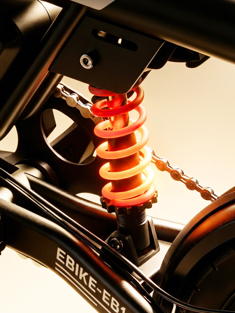 A close-up of the iScooter EB1S rear suspension system highlights the shock absorber positioned above the rear wheel and beneath the frame. Designed to absorb bumps and vibrations, the suspension enhances riding comfort and stability, allowing the iScooter EB1S to deliver a smoother and more controlled experience on city streets and uneven roads.
