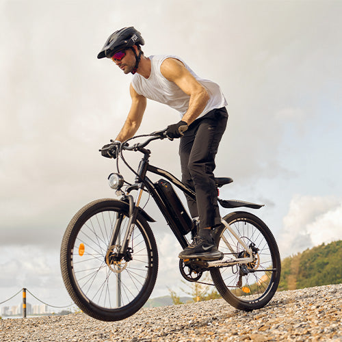 Action shot of the iHoverboard M50 on a gravel path, with the rider confidently navigating terrain using front suspension, disc brakes, and the integrated battery pack. This scene highlights the M50’s blend of power and control, delivering smooth performance and sustainable riding for both adventure and everyday travel.