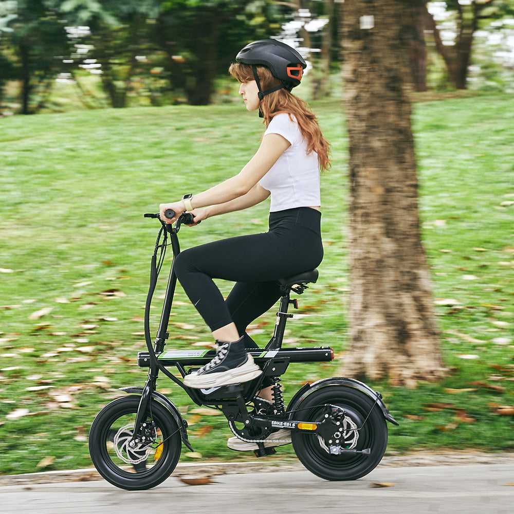 A side-profile action shot captures a rider using the iScooter EB1S electric bike along a tree-lined park path. The image highlights the compact folding frame, rear suspension, integrated battery, and upright riding position, showcasing how the iScooter EB1S delivers smooth handling, comfortable everyday riding, and practical mobility for commuting and recreational trips.
