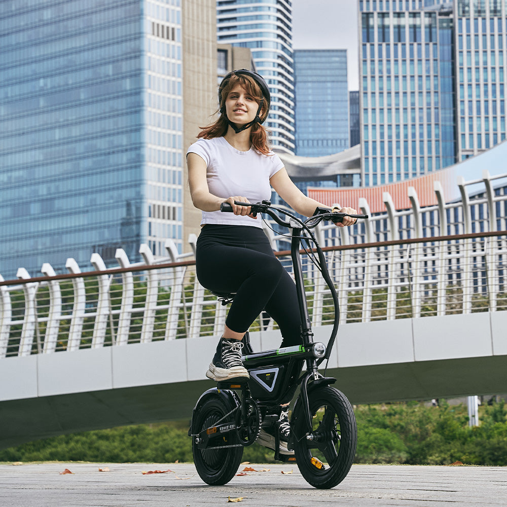 A rider travels through a modern cityscape on the iScooter EB1S electric bike, highlighting its compact folding frame, integrated battery, upright riding position, and sturdy wheels. The iScooter EB1S delivers smooth handling, everyday comfort, and a space-saving design, making it an excellent choice for urban commuting and convenient daily transportation.
