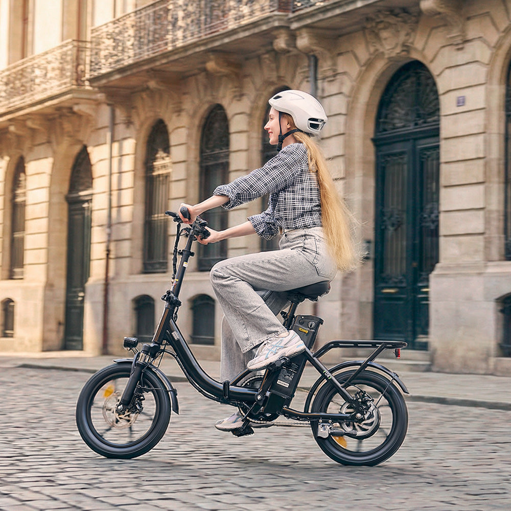 A rider cruises through a historic city street on the iScooter U4 electric bike, showcasing its low step-through frame, removable battery, rear cargo rack, and upright riding position. Set against classic architecture and cobblestone roads, the iScooter U4 combines everyday comfort, practical design, and smooth performance for effortless urban commuting and scenic rides.
